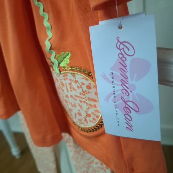 Bonnie Jean Orange Pumpkin Tunic with Cream Bows & Printed Leggings - Picture 5 of 9